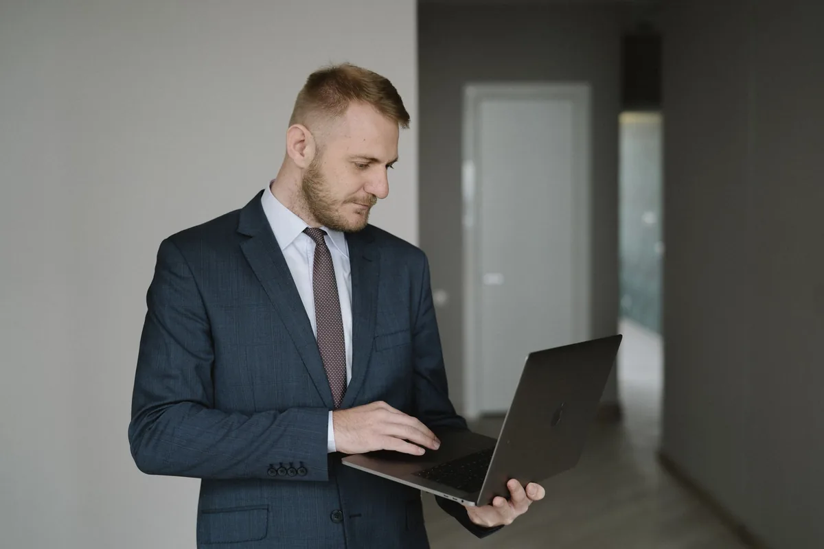 real estate investor checking numbers on laptop