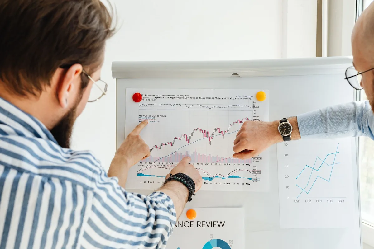 business professionals in a modern meeting room reviewing charts