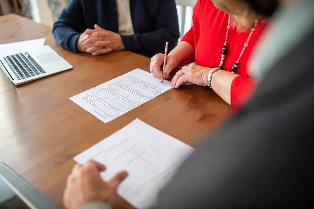 business executives signing contract table