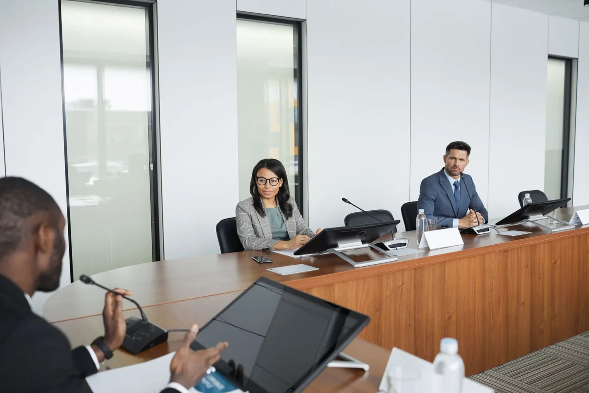 business executives seated boardroom table